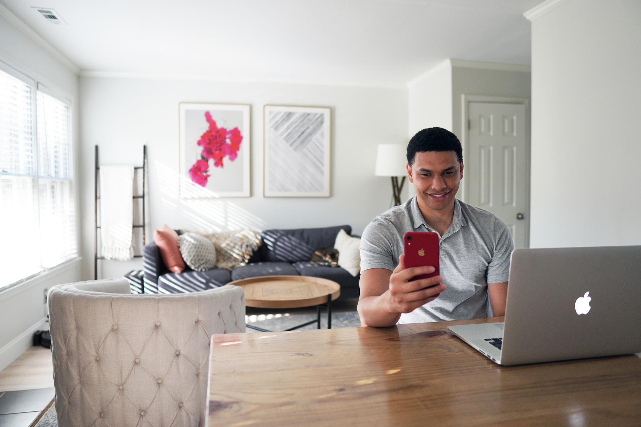 Image of a man with a laptop getting help with mortgage law enforcement from experts.