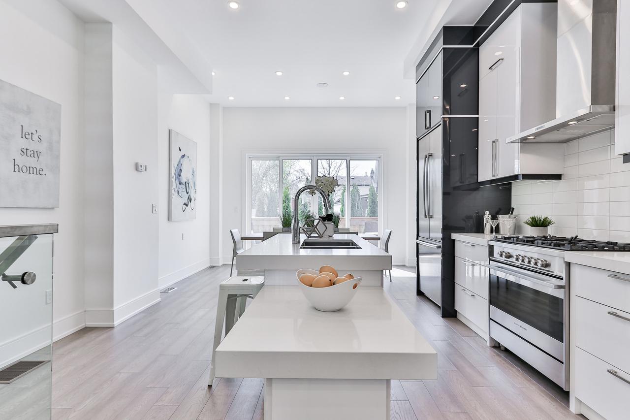 A kitchen with white and black cabinetry.