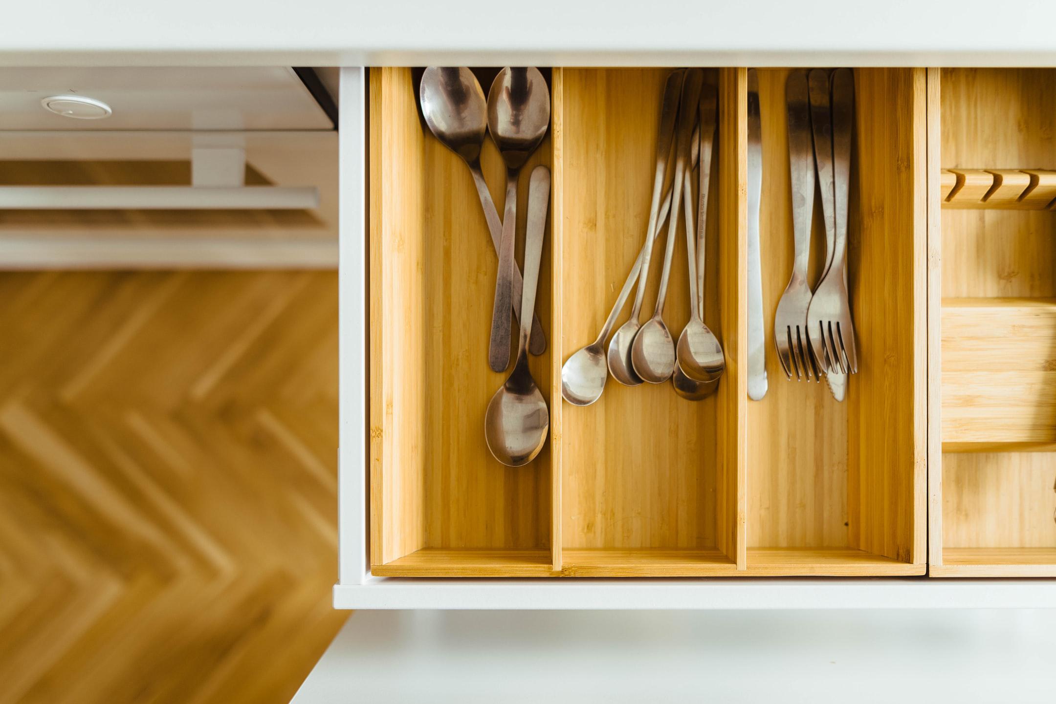 Drawers with utensils inside.