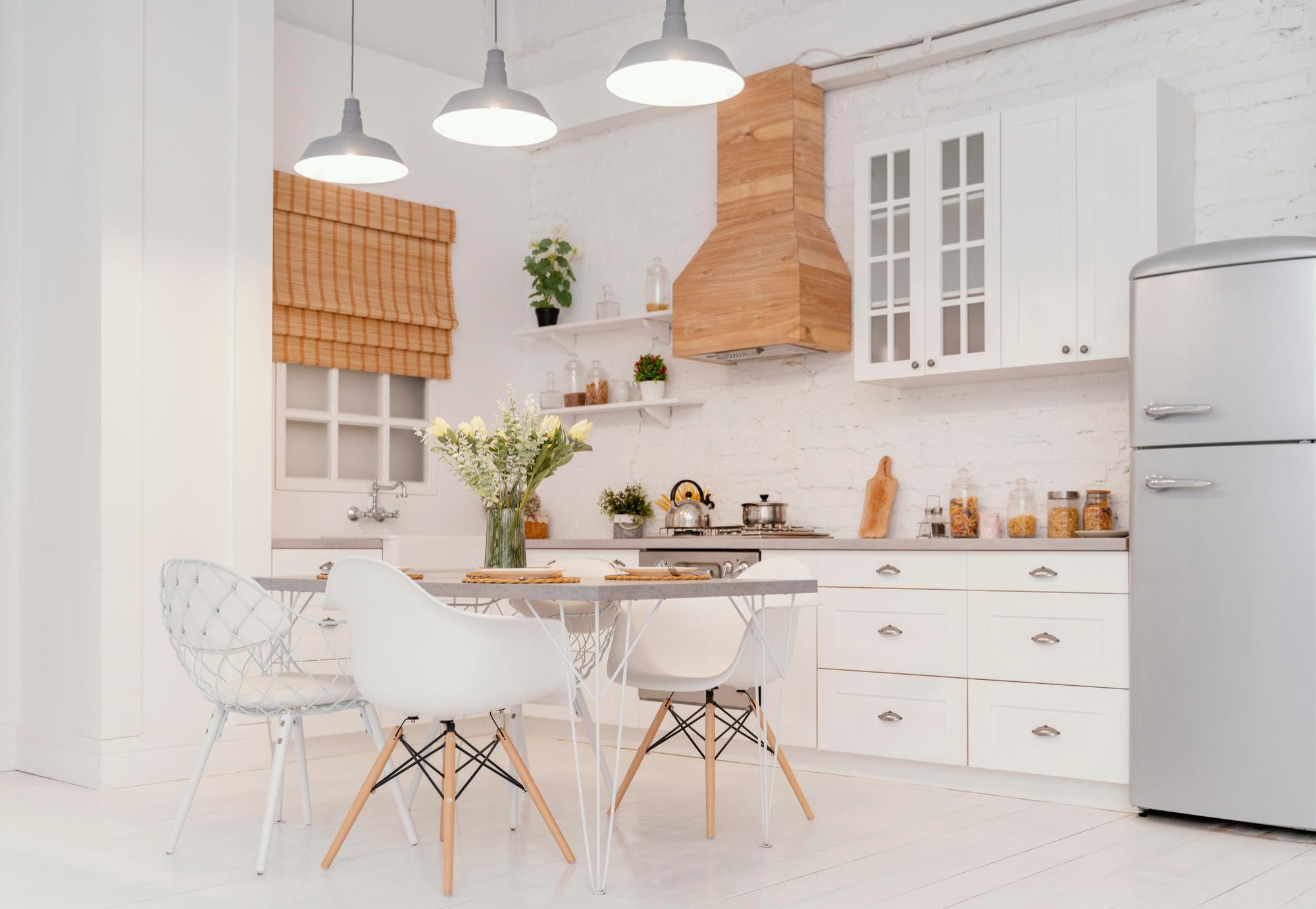 A kitchen with white floors and white walls and white cabinets and white chairs.