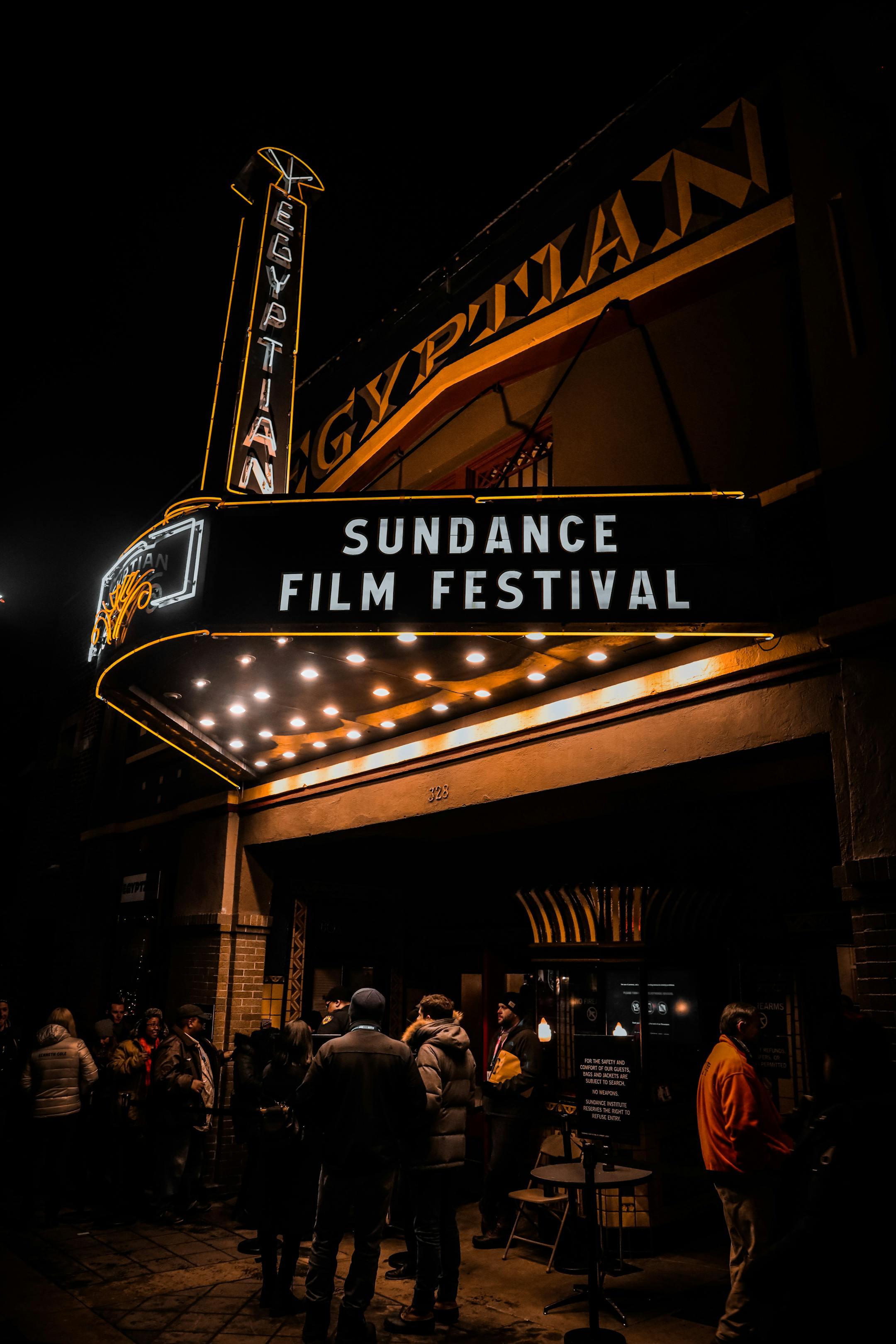 Crowds gather outside the illuminated Egyptian Theater during Sundance Film Festival at night.