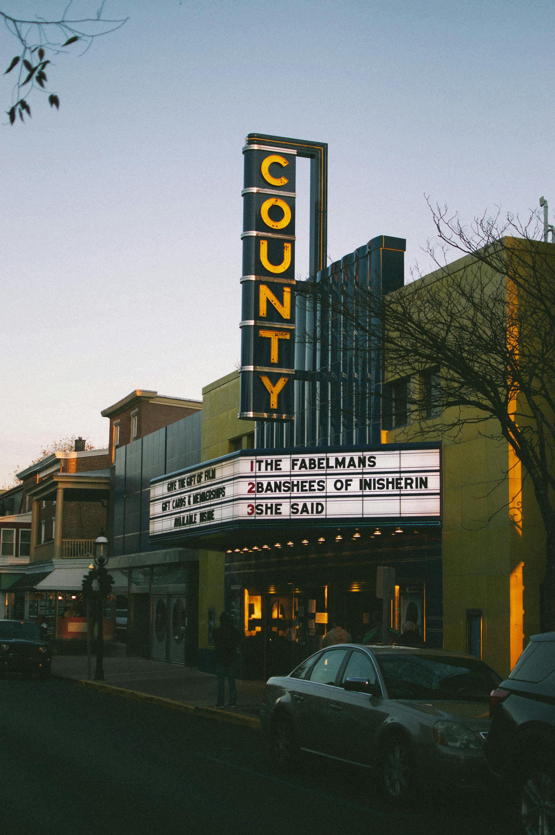 Classic theater exterior in Philadelphia at sunset with marquee lights.
