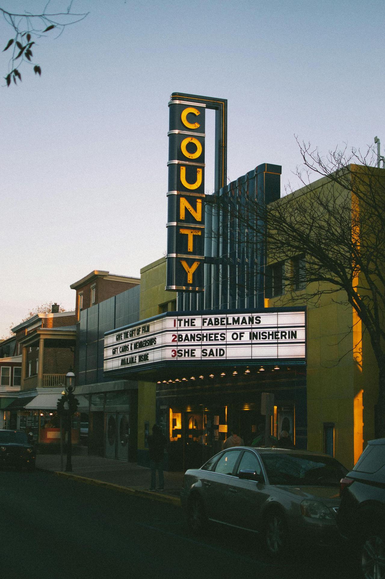 Classic theater exterior in Philadelphia at sunset with marquee lights.