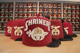 Shriners International emblem with red fez and crescent star
