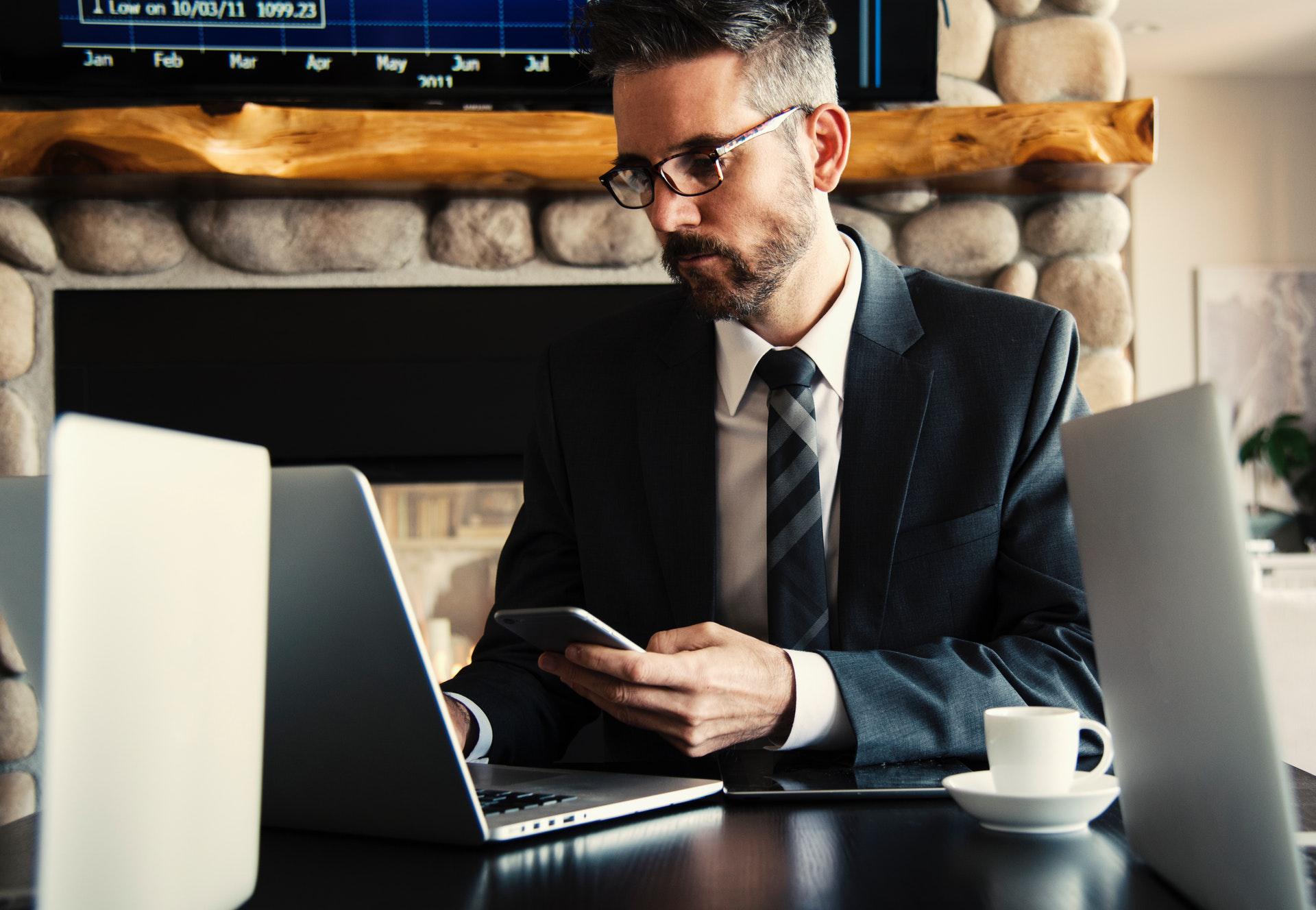 Man in suit working on his laptop