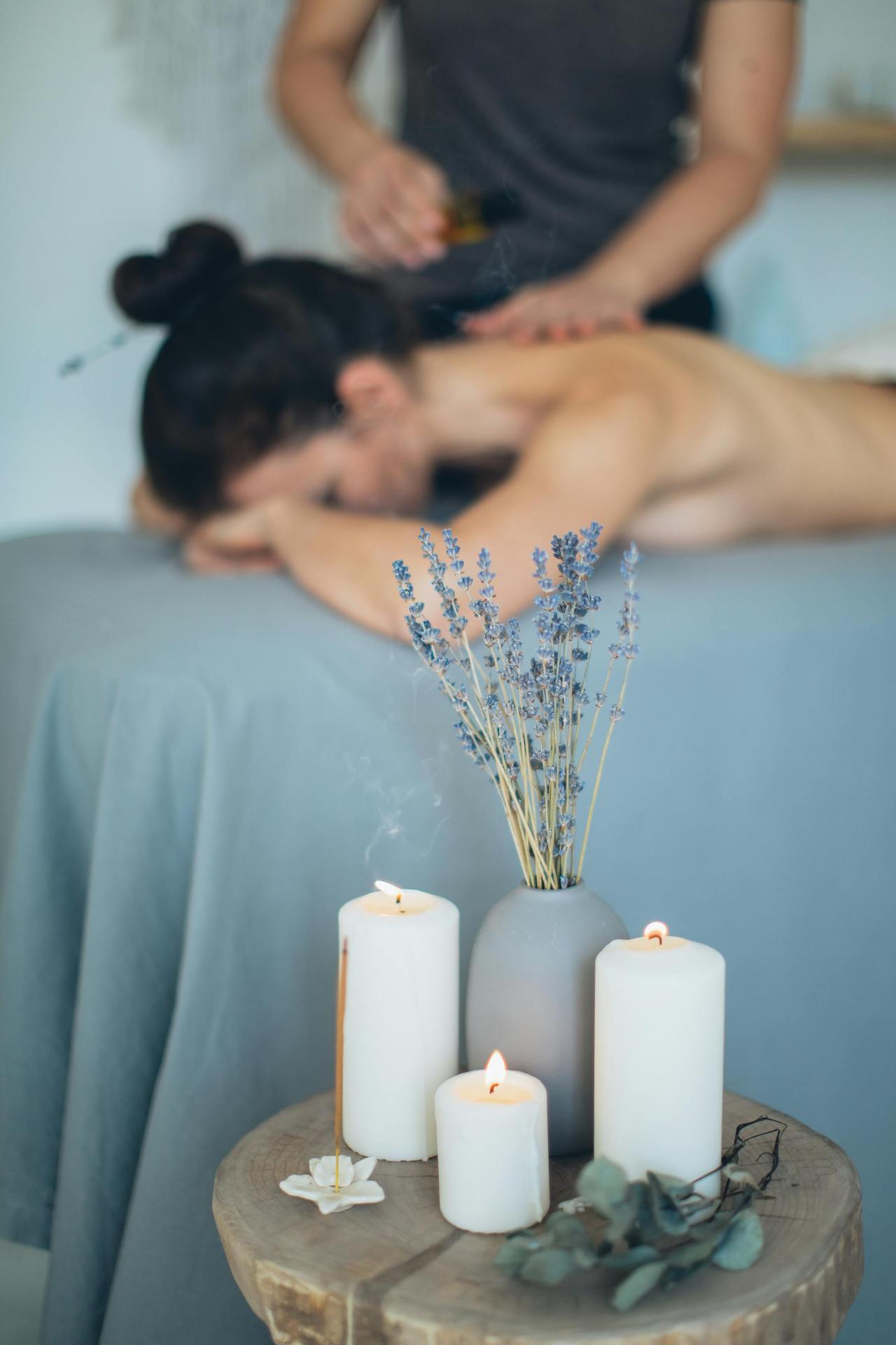 Soothing spa scene with massage, lavender, and candles promoting relaxation.