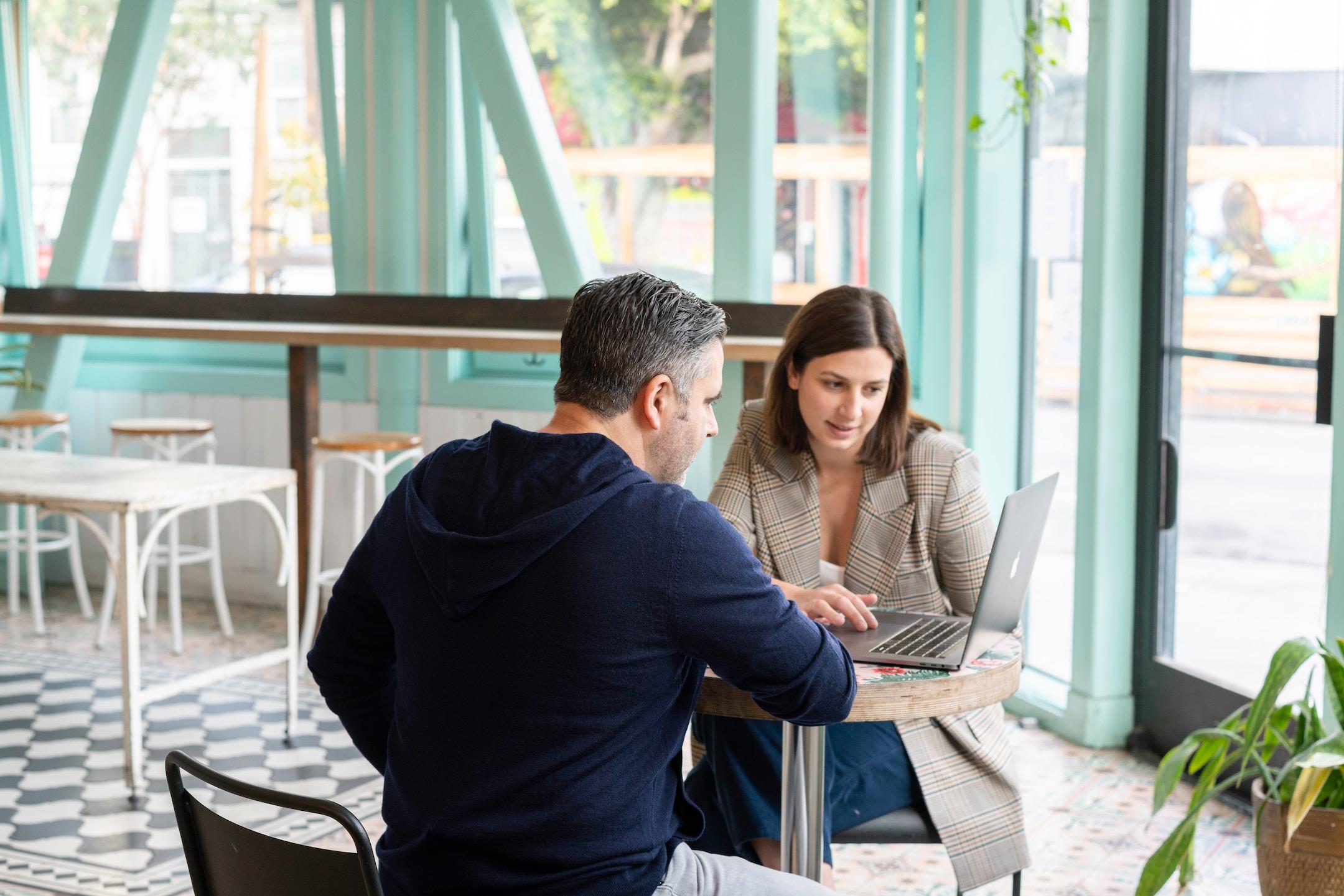 Businessman and businesswoman having a meeting about high-risk payment processing