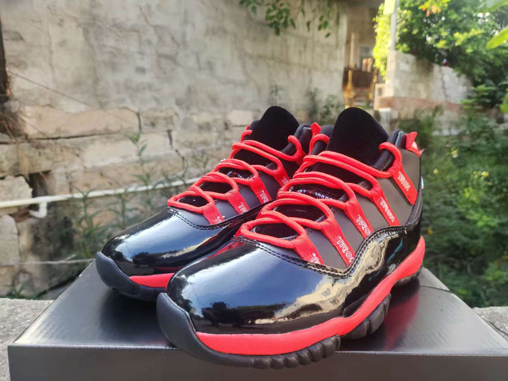 Air Jordan 11 Retro Tron Ares Custom alternate angle – black patent leather red laces detail