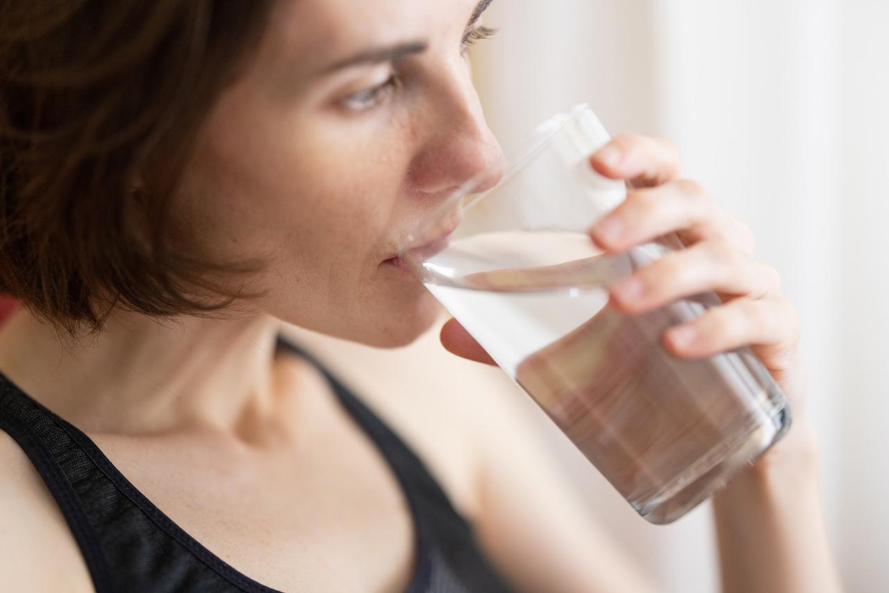 Image of a woman who has a Long Island water filter installed at home.