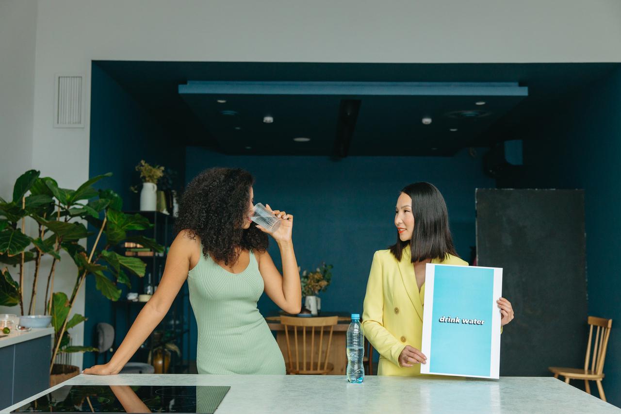 Woman drinking water in the kitchen