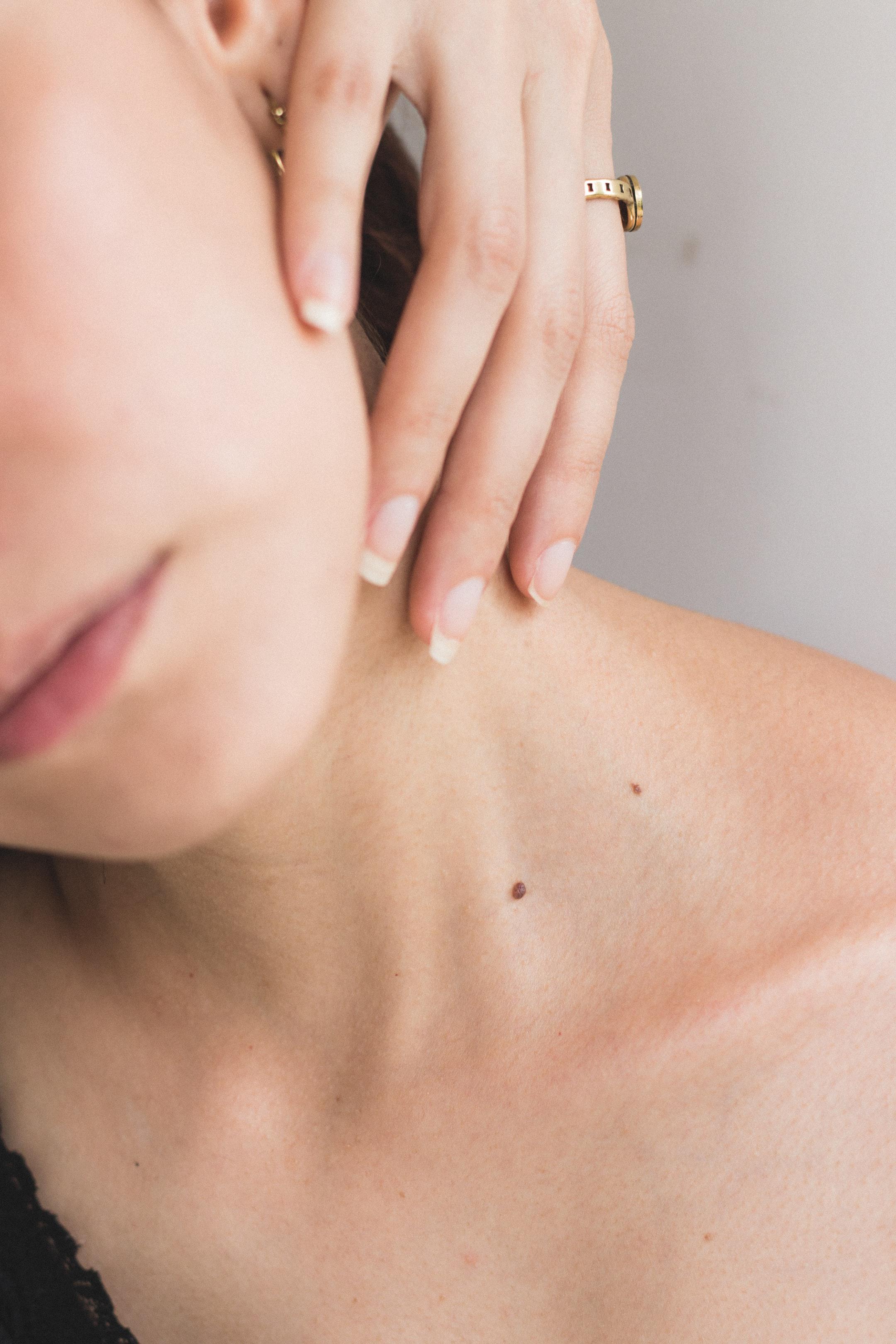 Image of a woman's neck with a hand from a massage therapist in Bergen County, NJ.