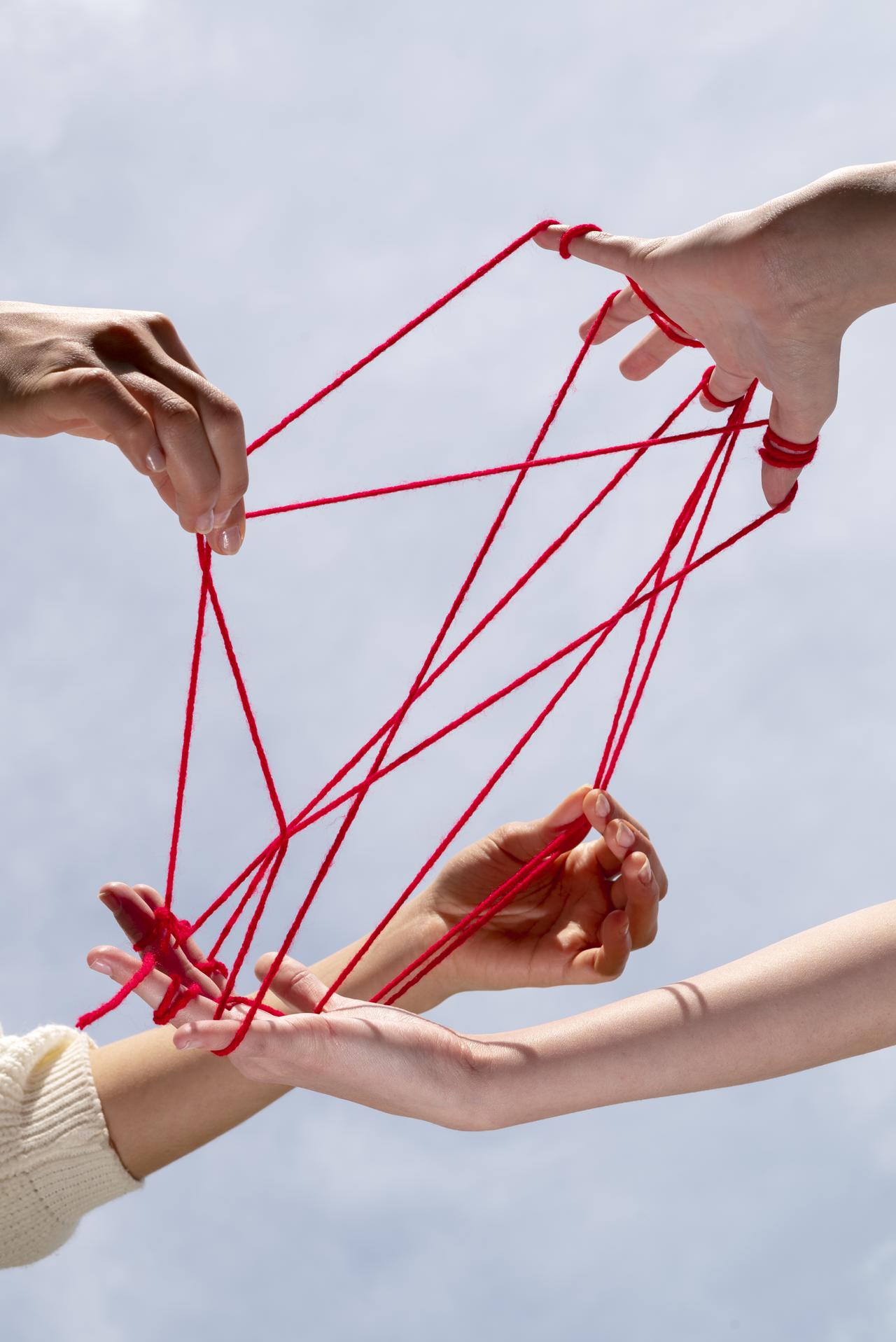 human-hands-connected-with-red-thread.jpg