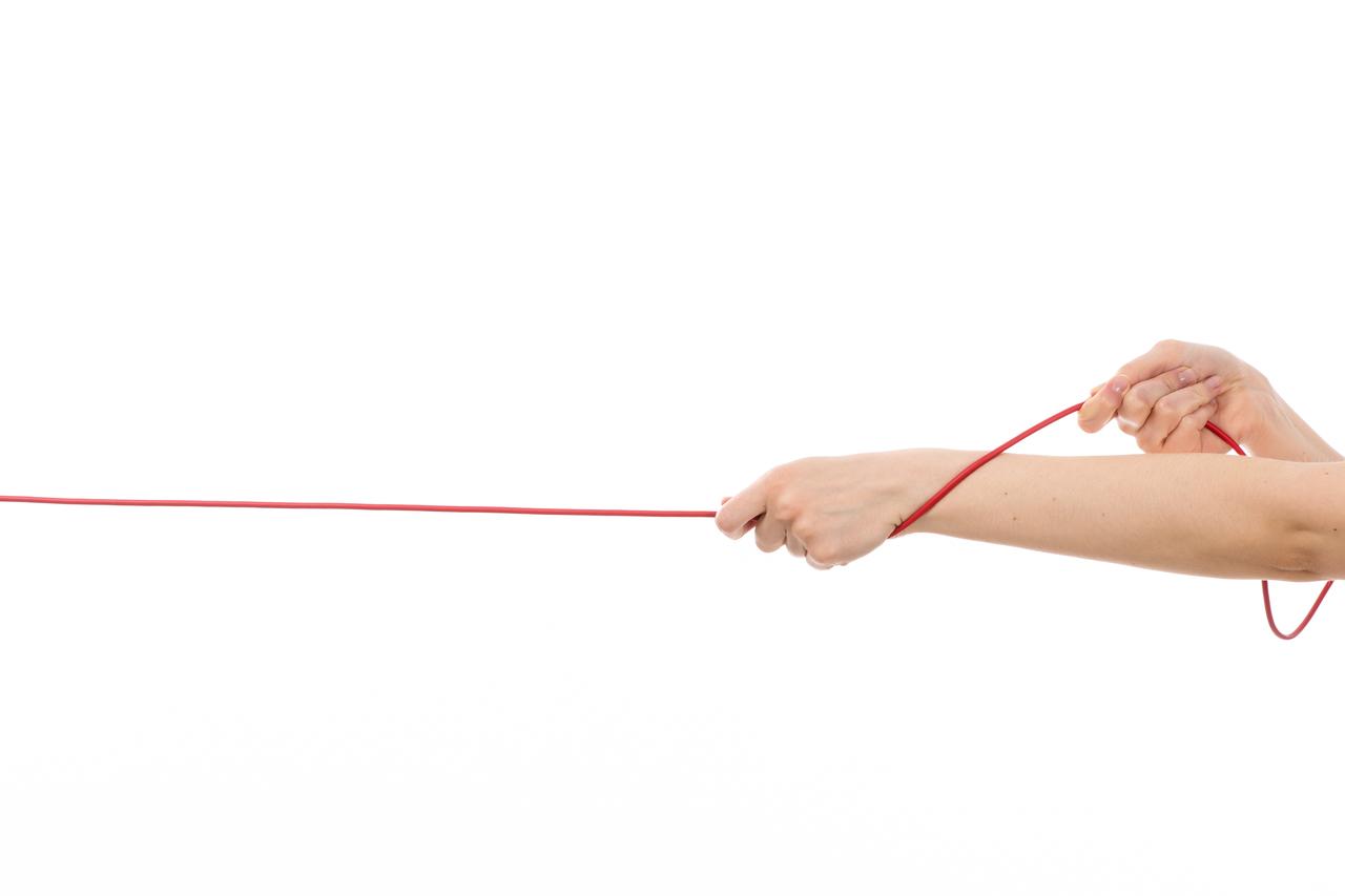 front-view-female-hand-pulling-up-red-rope-white.jpg