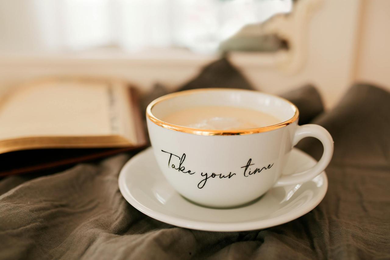 White coffee cup and open book create a tranquil, cozy atmosphere.