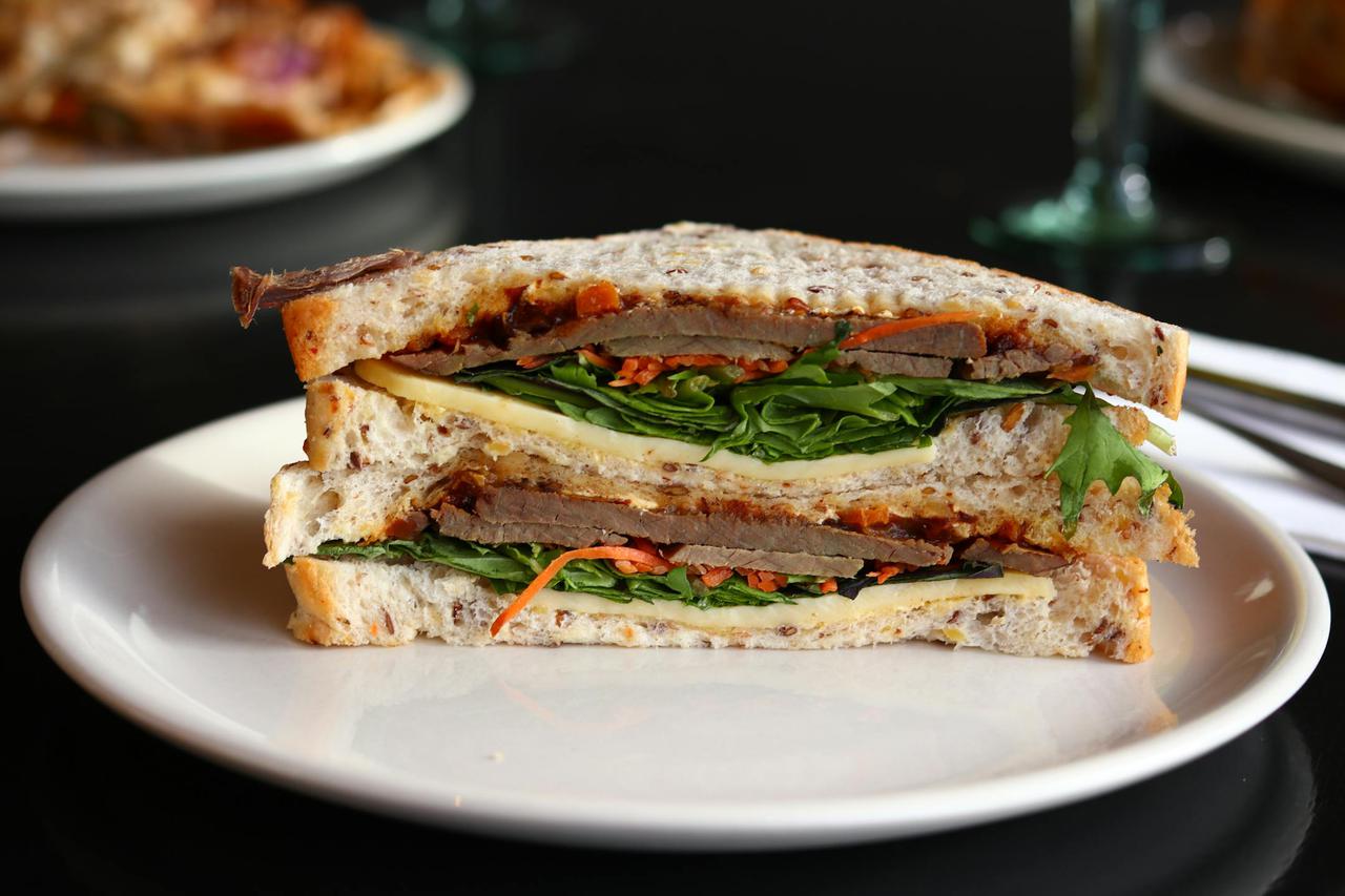 Close-up of a hearty sandwich with fresh ingredients, ready to enjoy.