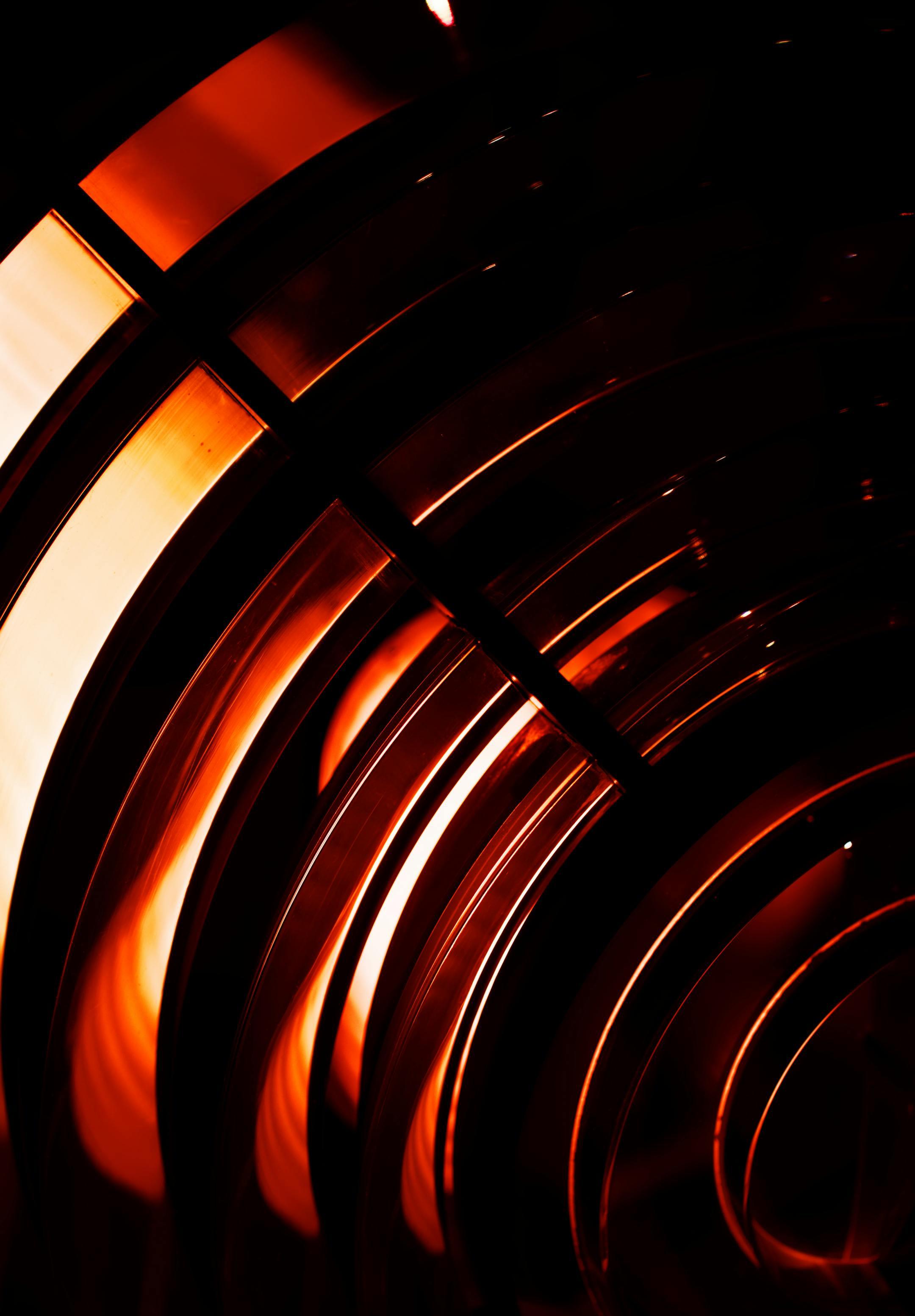 Vibrant abstract image featuring glowing red spirals and curves forming a dynamic pattern.