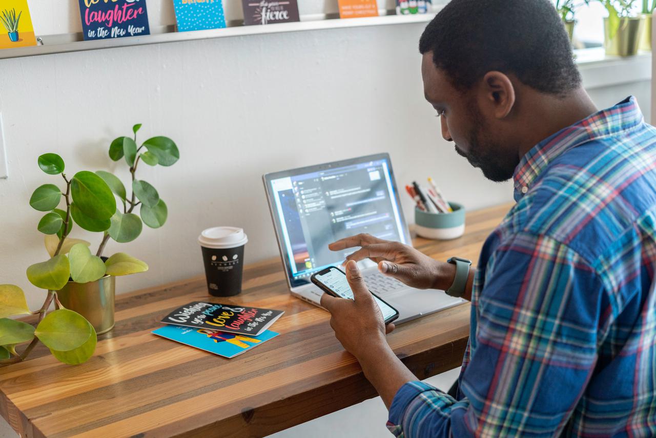 A salesperson working in an office at laptop