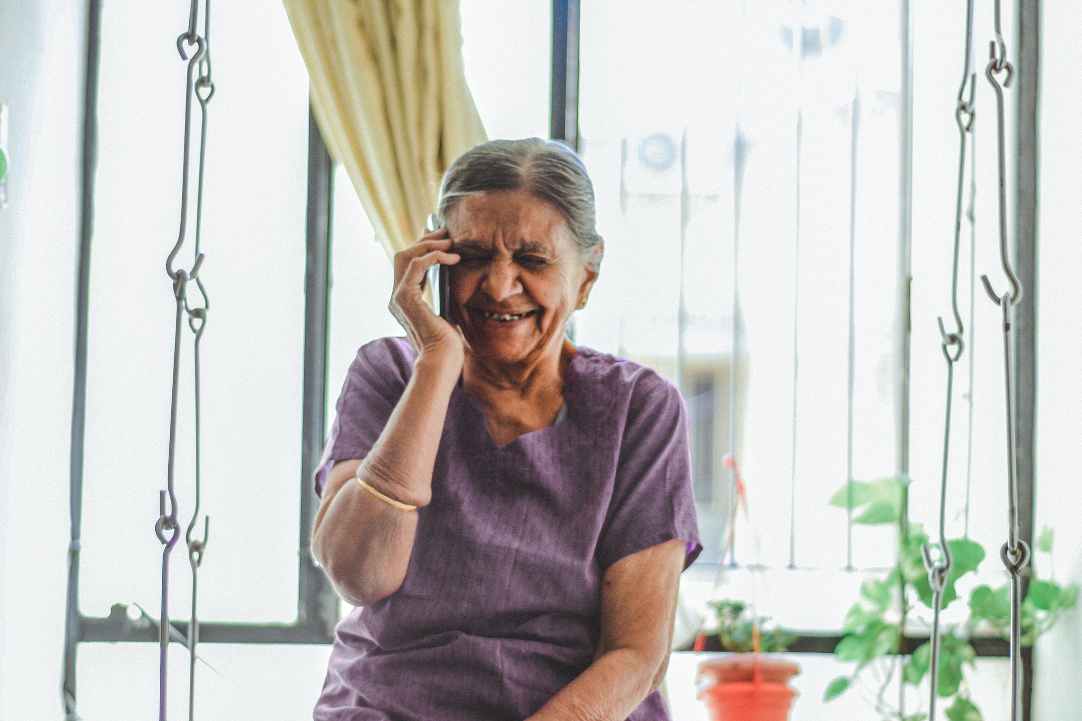 An old woman making a phone call.