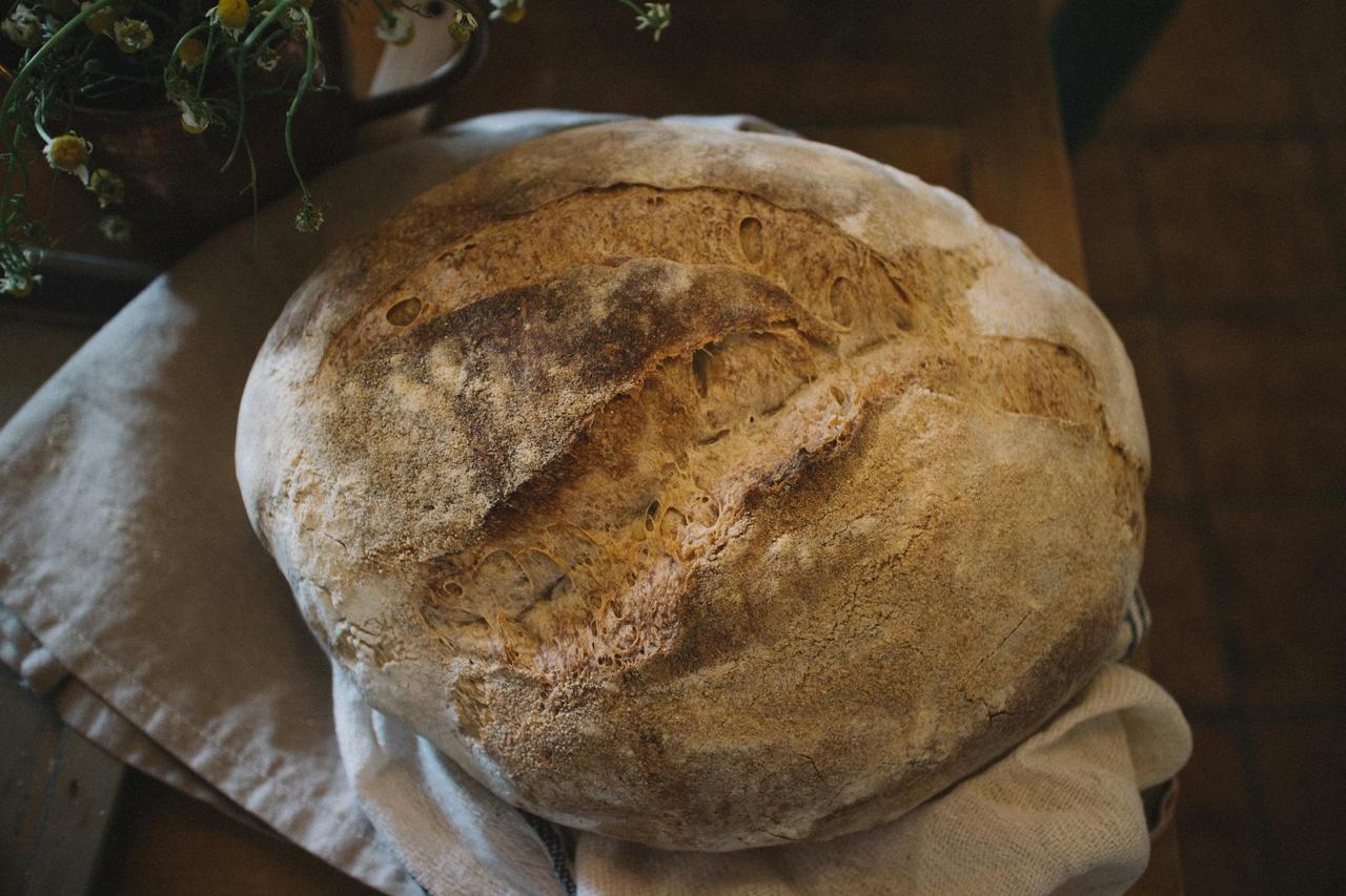 A close-up of homemade rustic sourdough bread, highlighting its texture and crust.