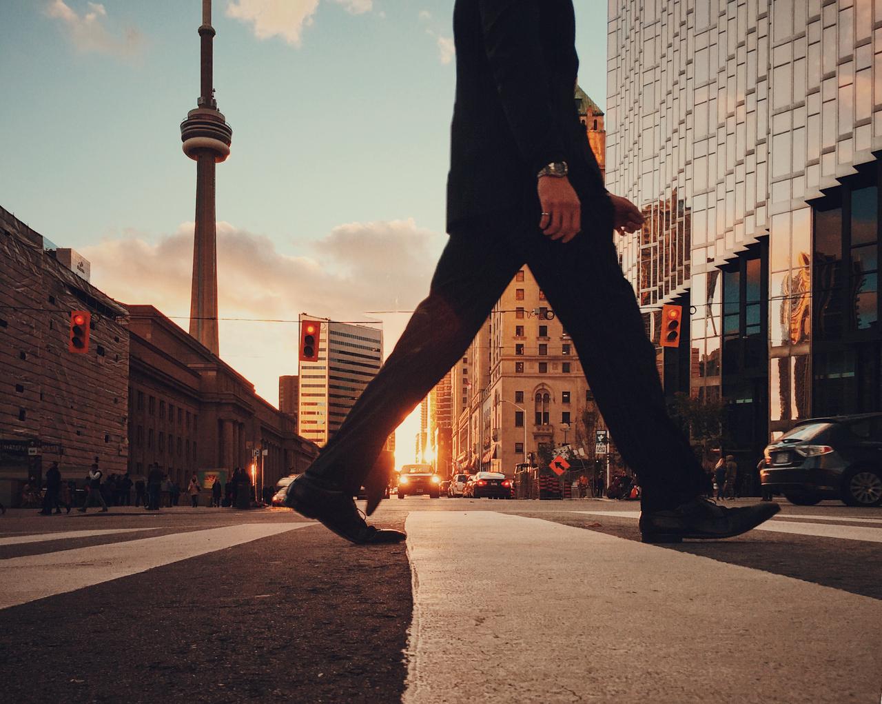 A man in a suit crossing the street.