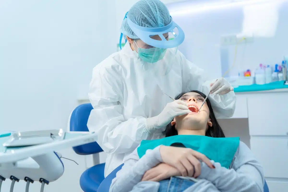 Dentist providing care to patient at Confident Smiles