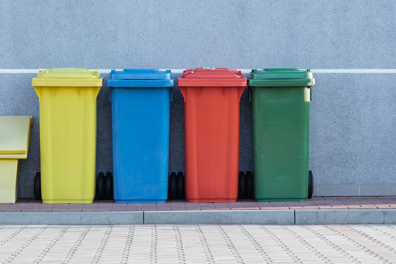 Differently-colored bins for storing different types of recyclables.