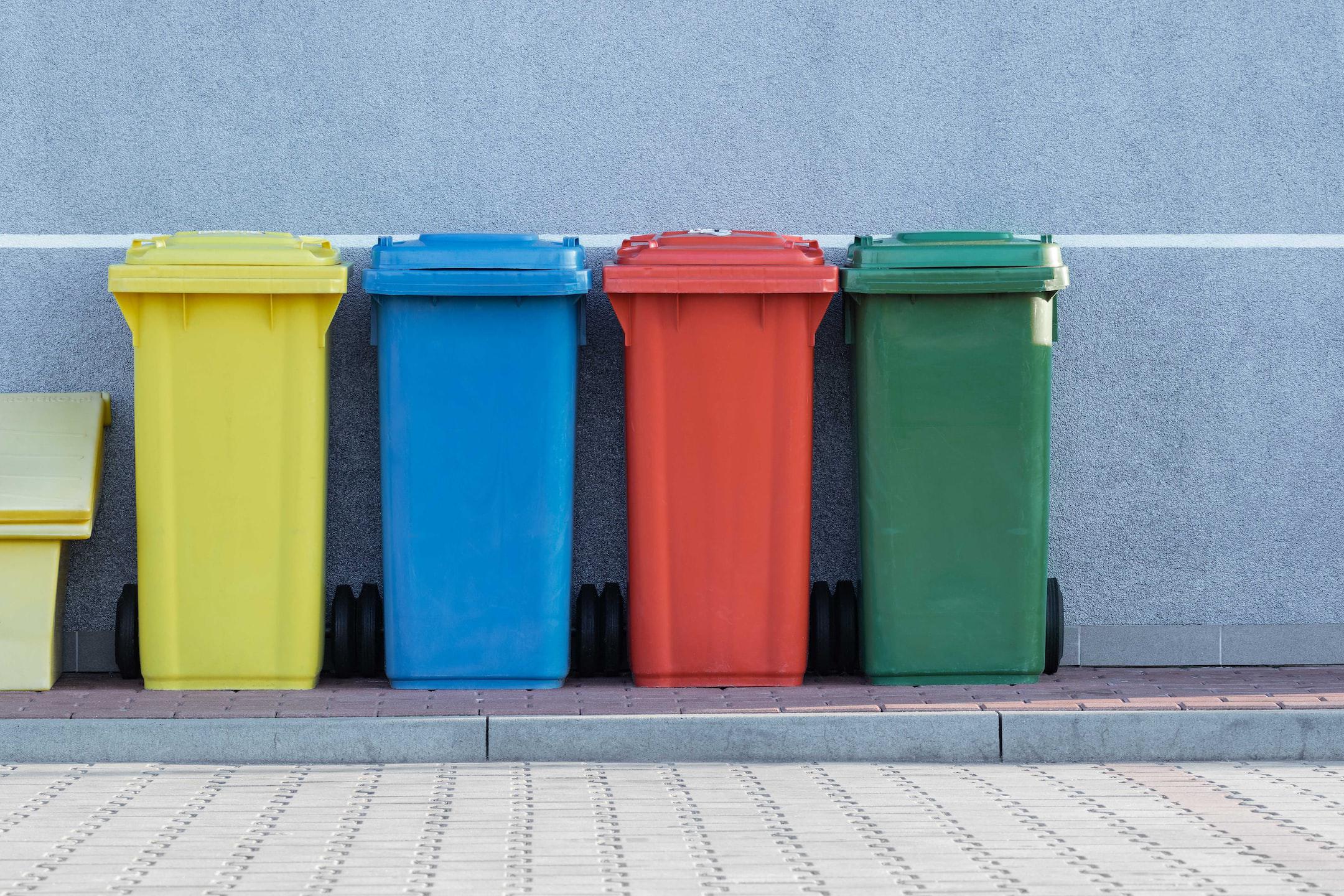Image of four trash cans made from recycled resin.