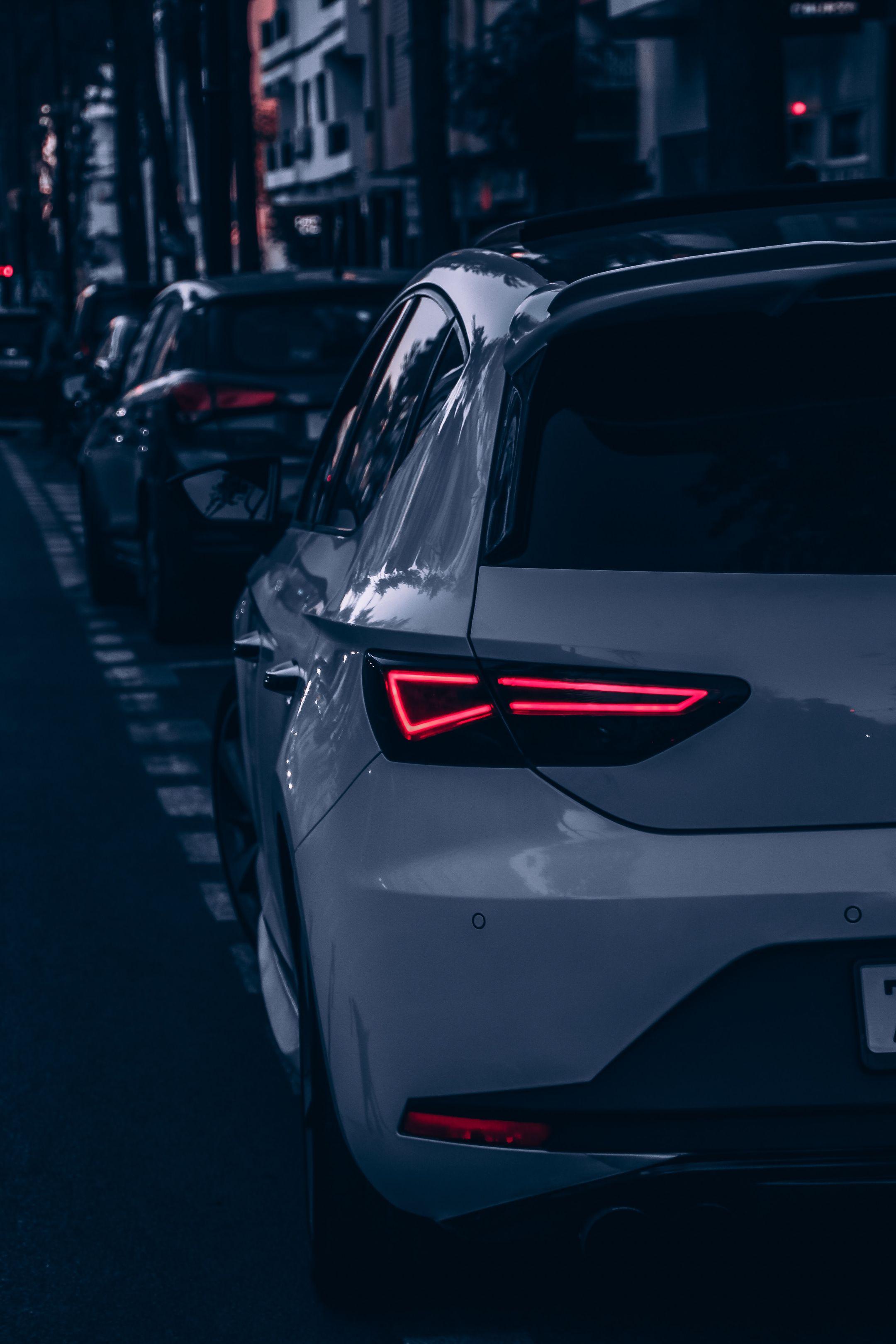 Rearview of cars on a city street in Rabat at night, highlighting urban transportation.