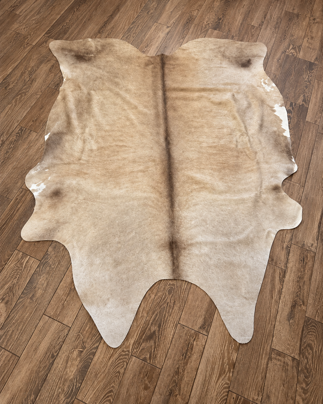 Brazil-made cowhide rug with a natural outline and cream and tan markings