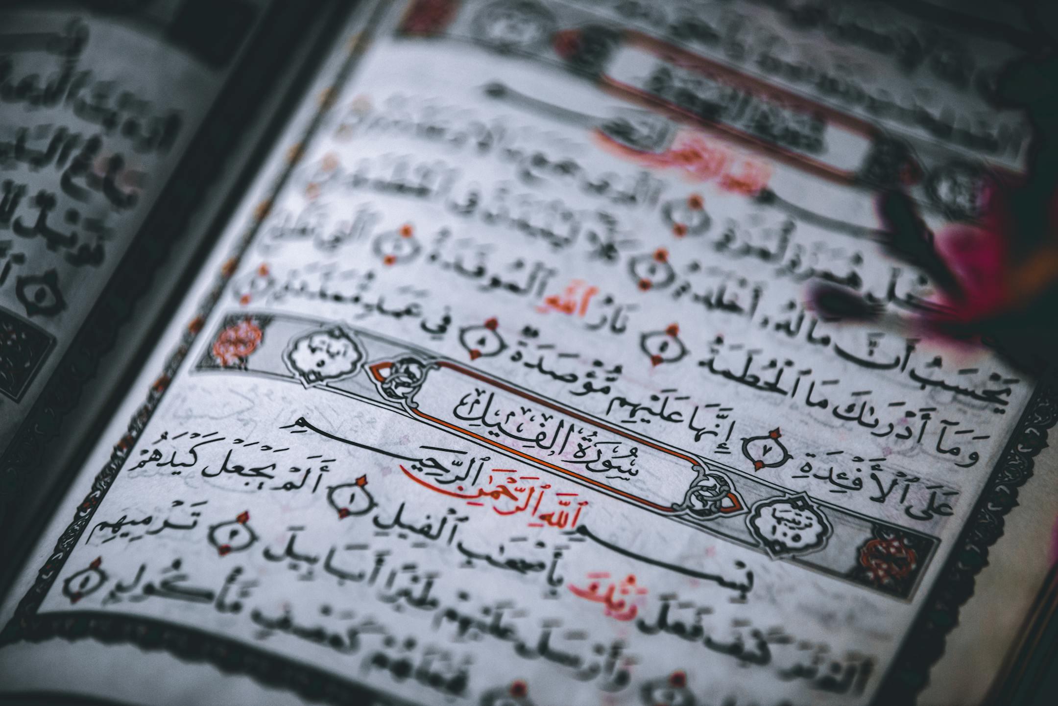 Detailed close-up of the Quran showing Arabic calligraphy and intricate designs.