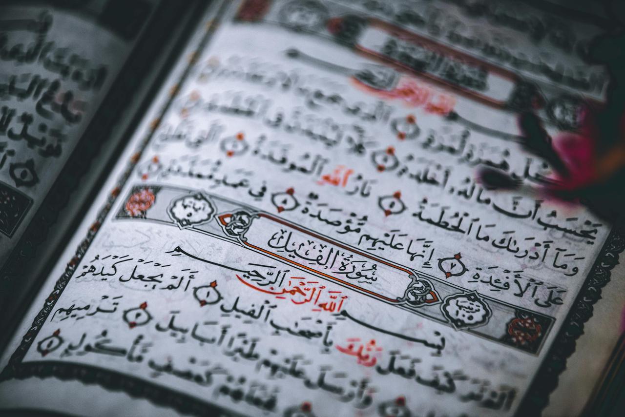 Detailed close-up of the Quran showing Arabic calligraphy and intricate designs.