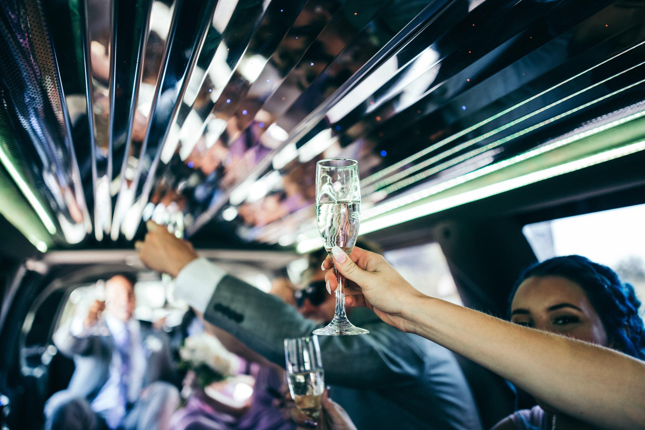 Image of a wedding party who booked the best charter bus company in San Diego.