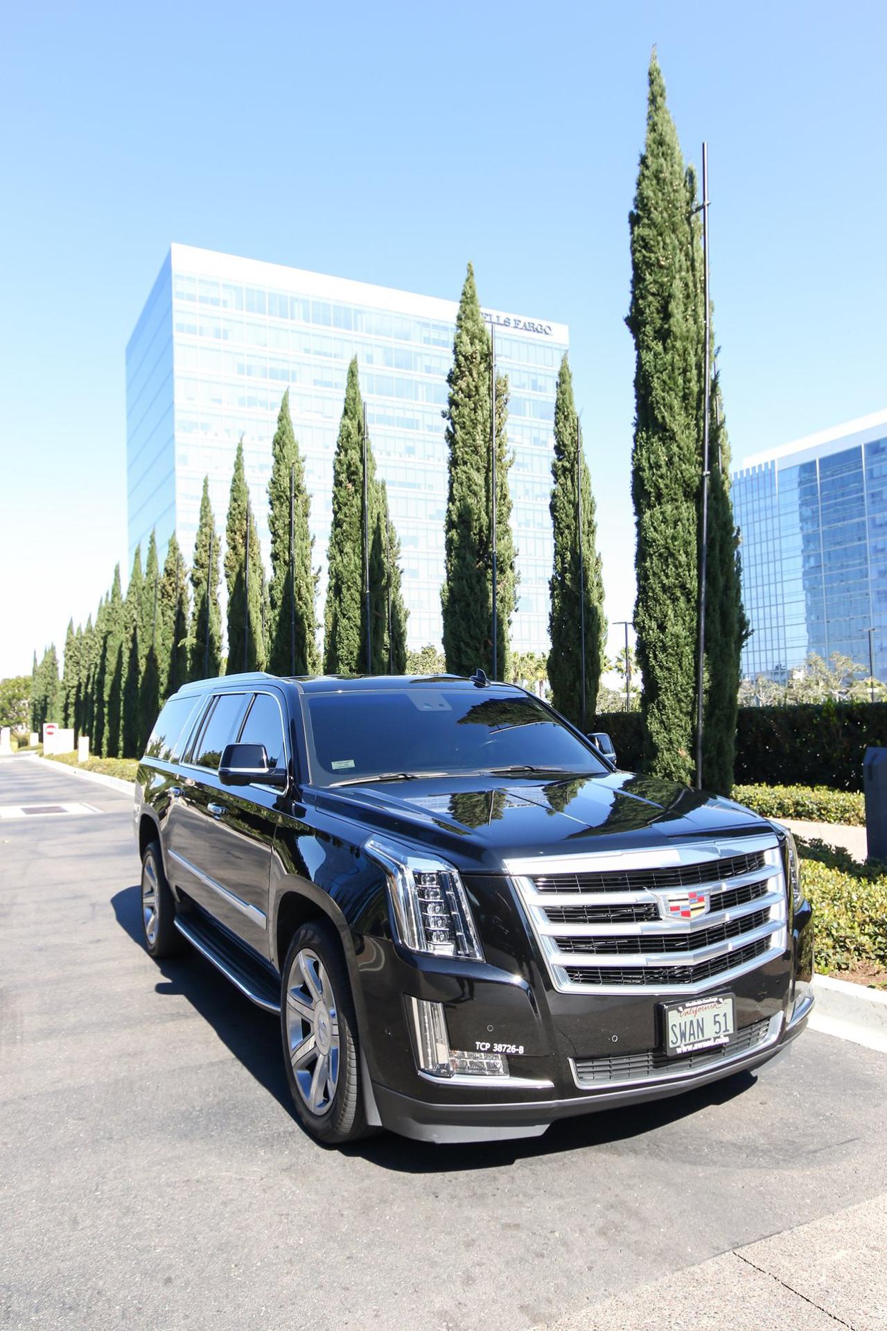 A luxury black car in the California sun, one of the many vehicles we offer in our San Diego private car service.