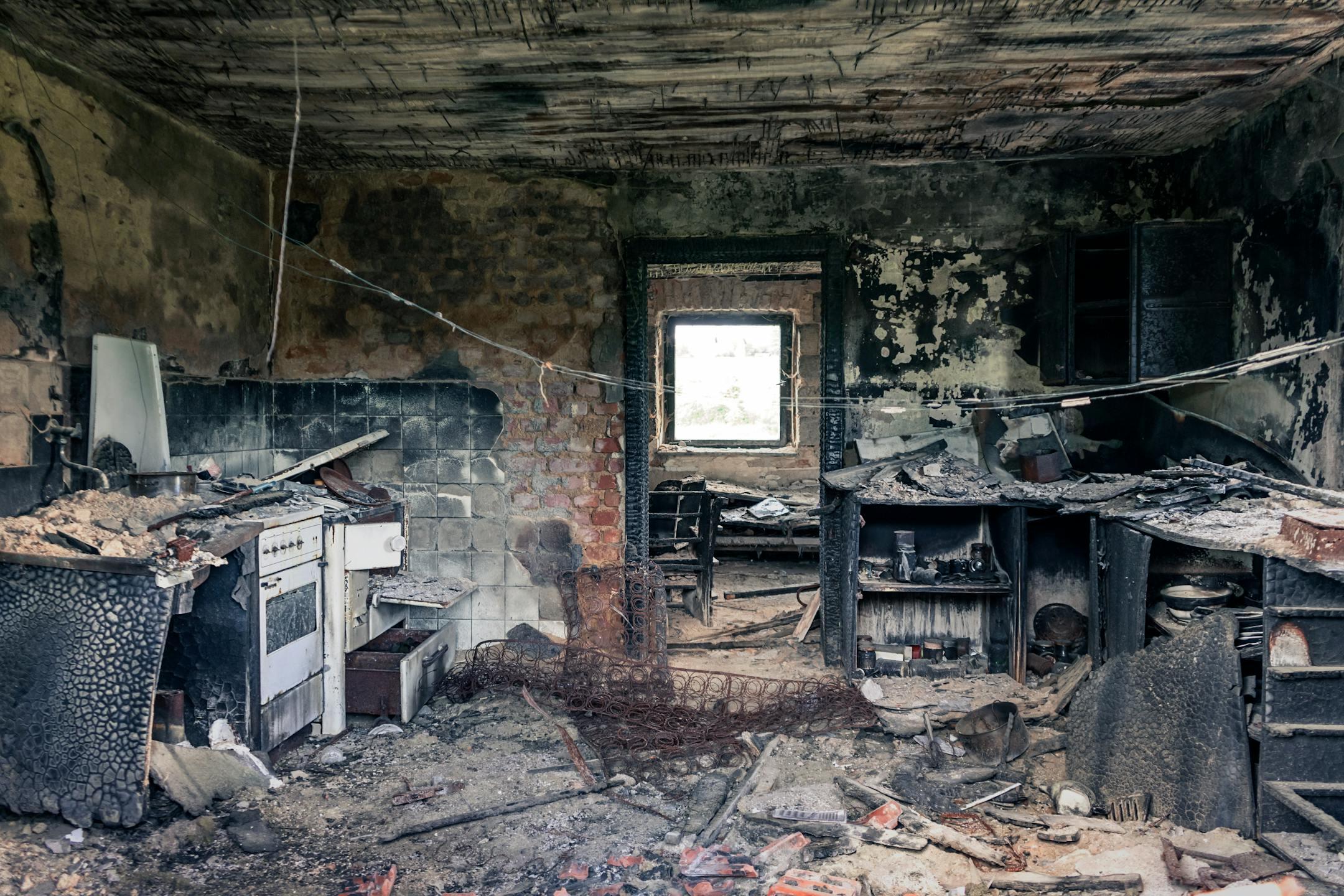Explore an abandoned, fire-damaged kitchen illustrating decay and destruction.