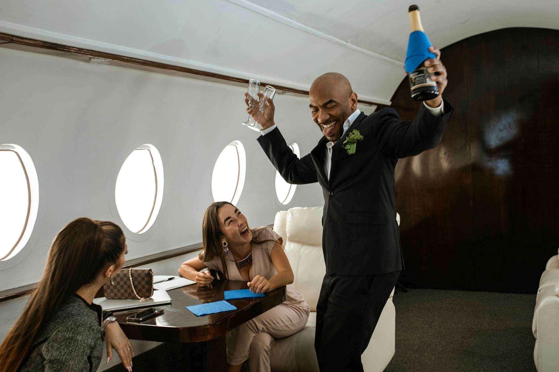Joyful passengers celebrating with champagne on a private jet