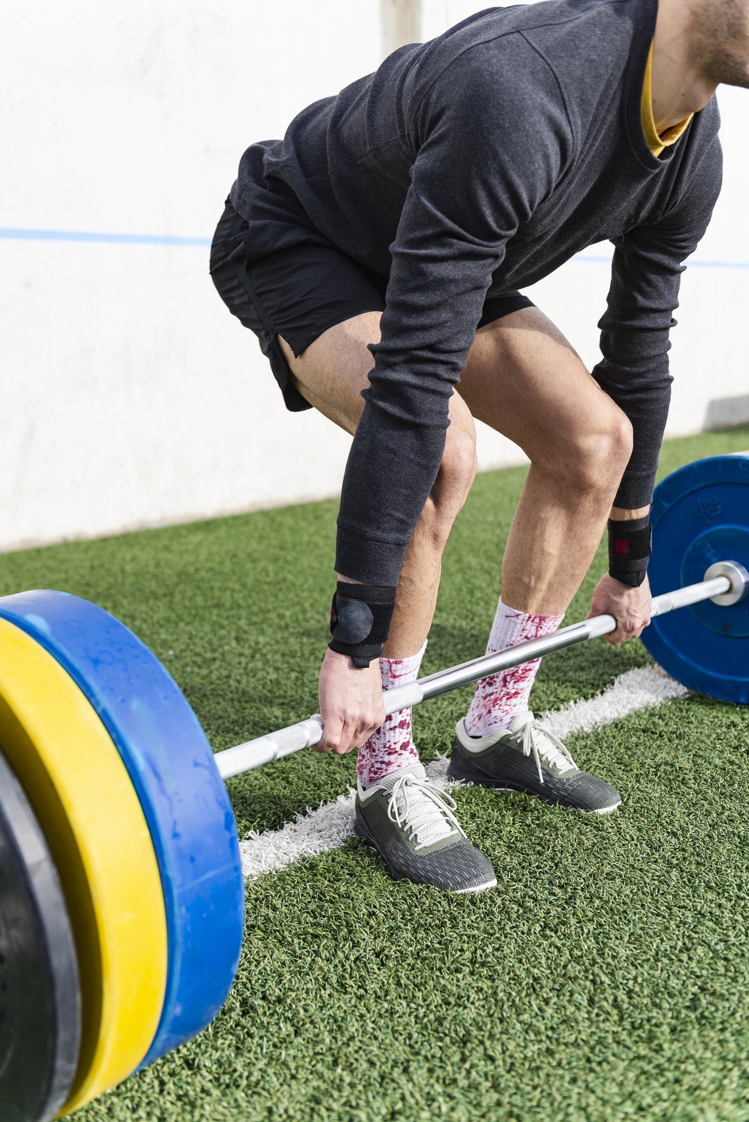 man-performing-a-deadlift-outdoors-on-artificial-t-2026-01-09-08-40-22-utc.jpg