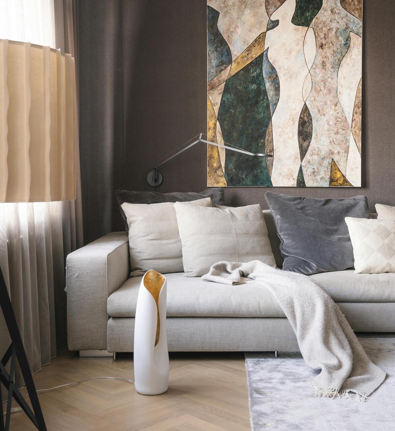 Elegant contemporary living room interior featuring abstract art and stylish furniture.