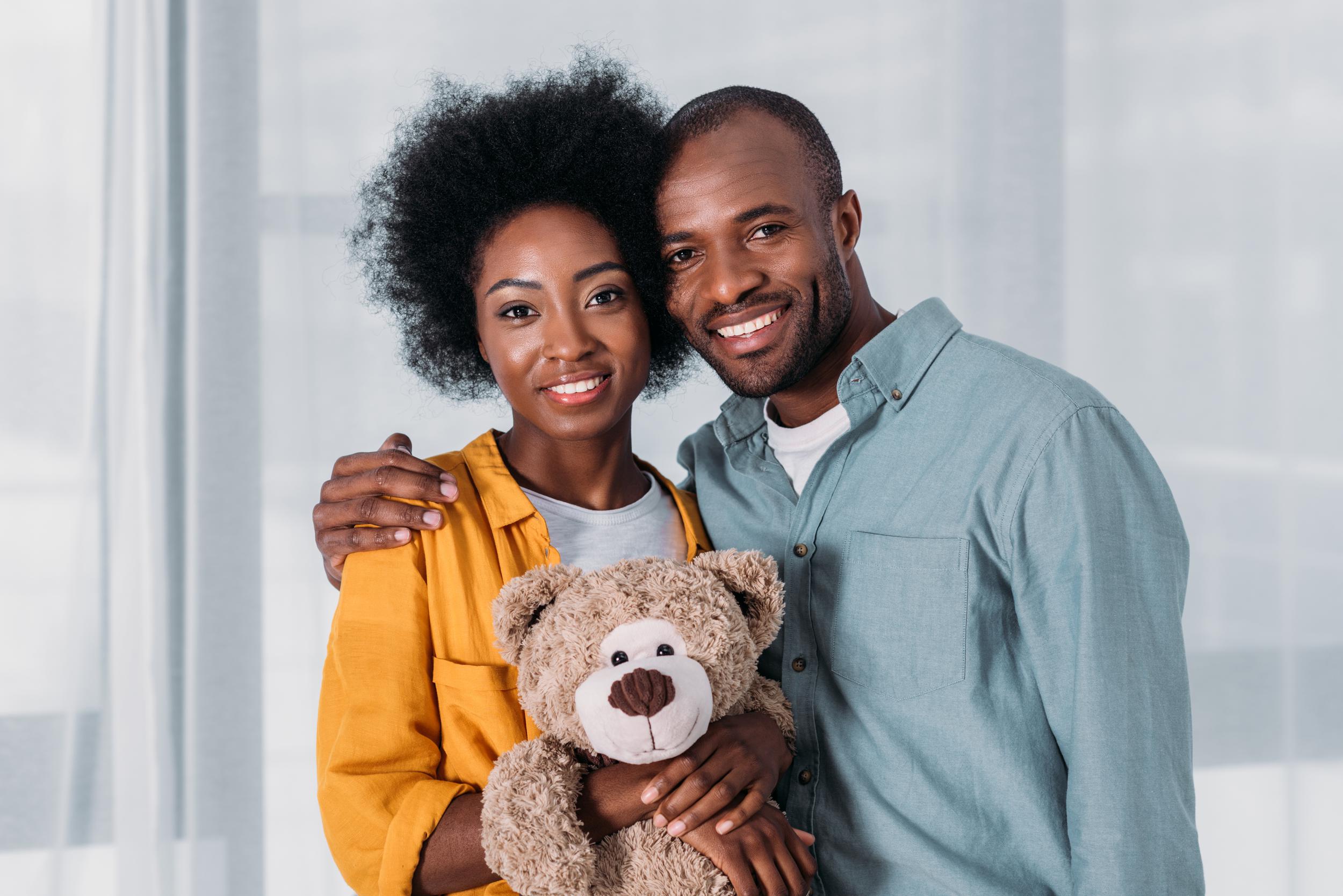 happy-african-american-couple-with-teddy-bear-at-h-2024-11-10-20-40-20-utc.jpg
