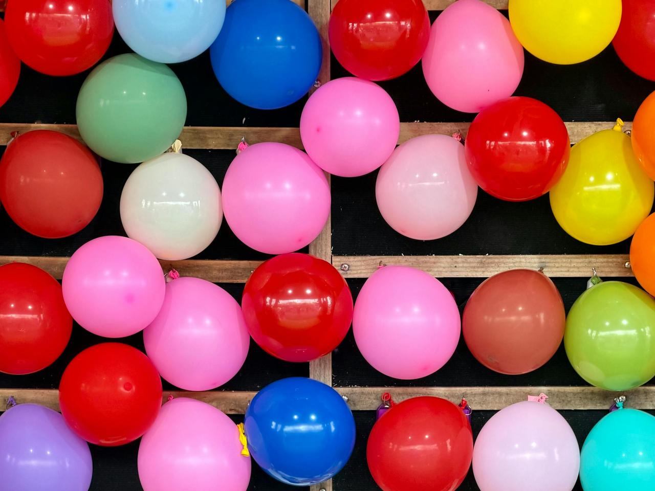 Vibrant balloons at a funfair stall, creating a cheerful atmosphere in Ascot Vale, Australia.