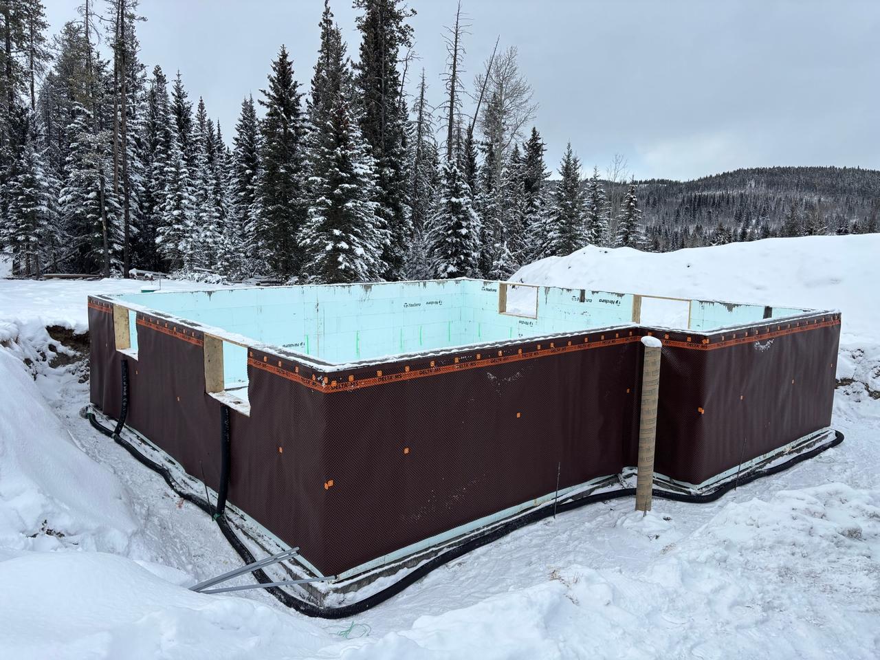 Professional ICF construction team at work on foundation project
