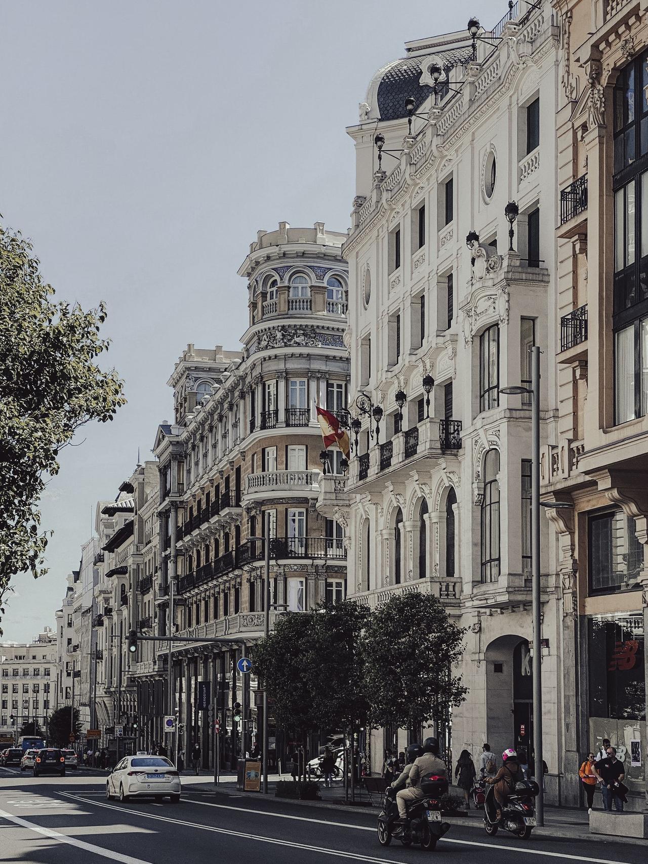Beautiful city street featuring historic European architecture and bustling urban life.