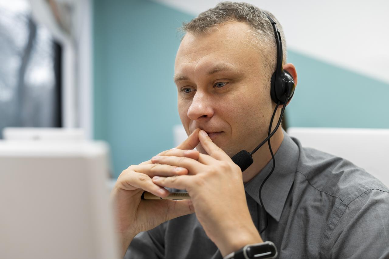 man-working-call-center-with-headphones-computer.jpg