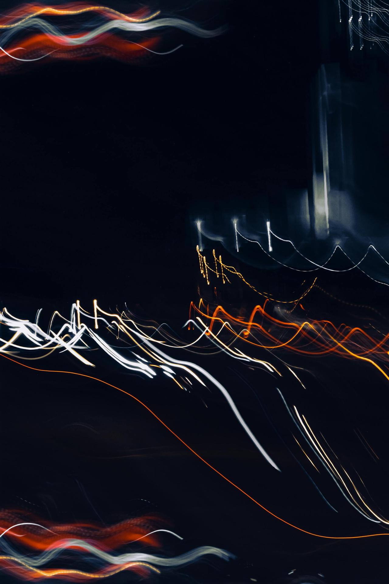 Vibrant abstract light trails against a dark night background, showcasing motion and creativity.