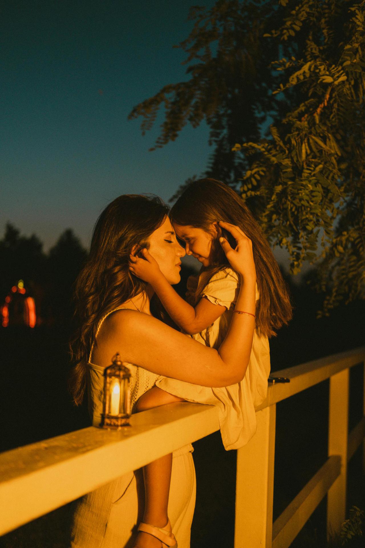 A warm embrace between a mother and daughter at twilight in Baku, Azerbaijan, capturing love and serenity.
