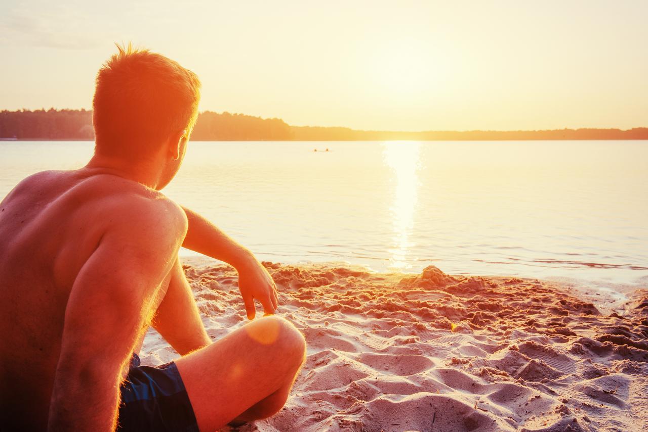 man-sitting-on-the-sand-at-sunset-2025-03-18-20-58-27-utc.jpg