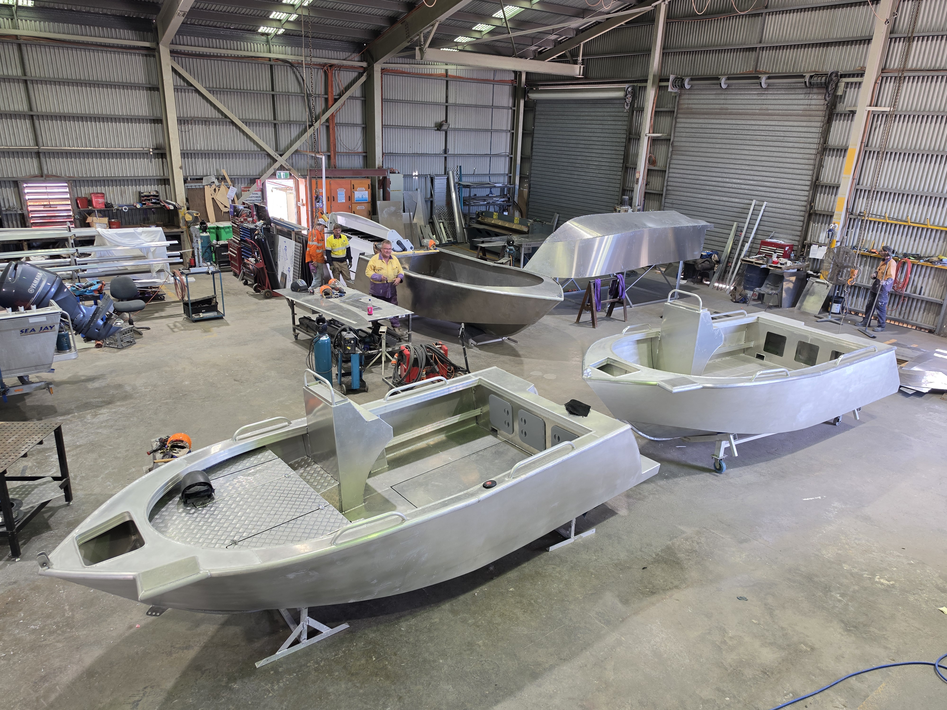 Boat fabrication workshop with welding and construction