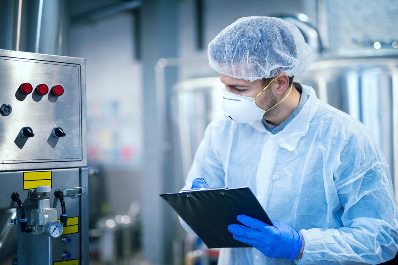 technologist-expert-protective-uniform-with-hairnet-mask-taking-parameters-from-industrial-machine-food-production-plant.jpg