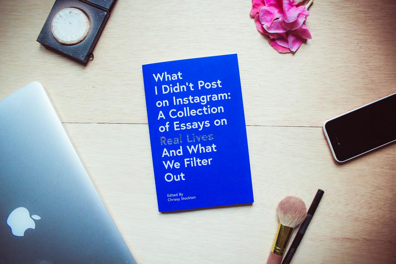 A table or desktop setting of the book, “What I Didn’t Post on Instagram” surrounded by objects one might use to prepare for a selfie (makeup, iPhone, laptop). We asked women to share the truth behind their Instagram photos for a collection of essays. The book ‘What I Didn’t Post On Instagram’ by Chrissy Stockton exposes that we are all a little confused when it comes to life. We are all just trying to belong. The essays housed in this collection are deeply honest, real, and make you feel seen and connected