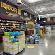 Well-stocked liquor store shelves with wines, whiskeys, and spirits
