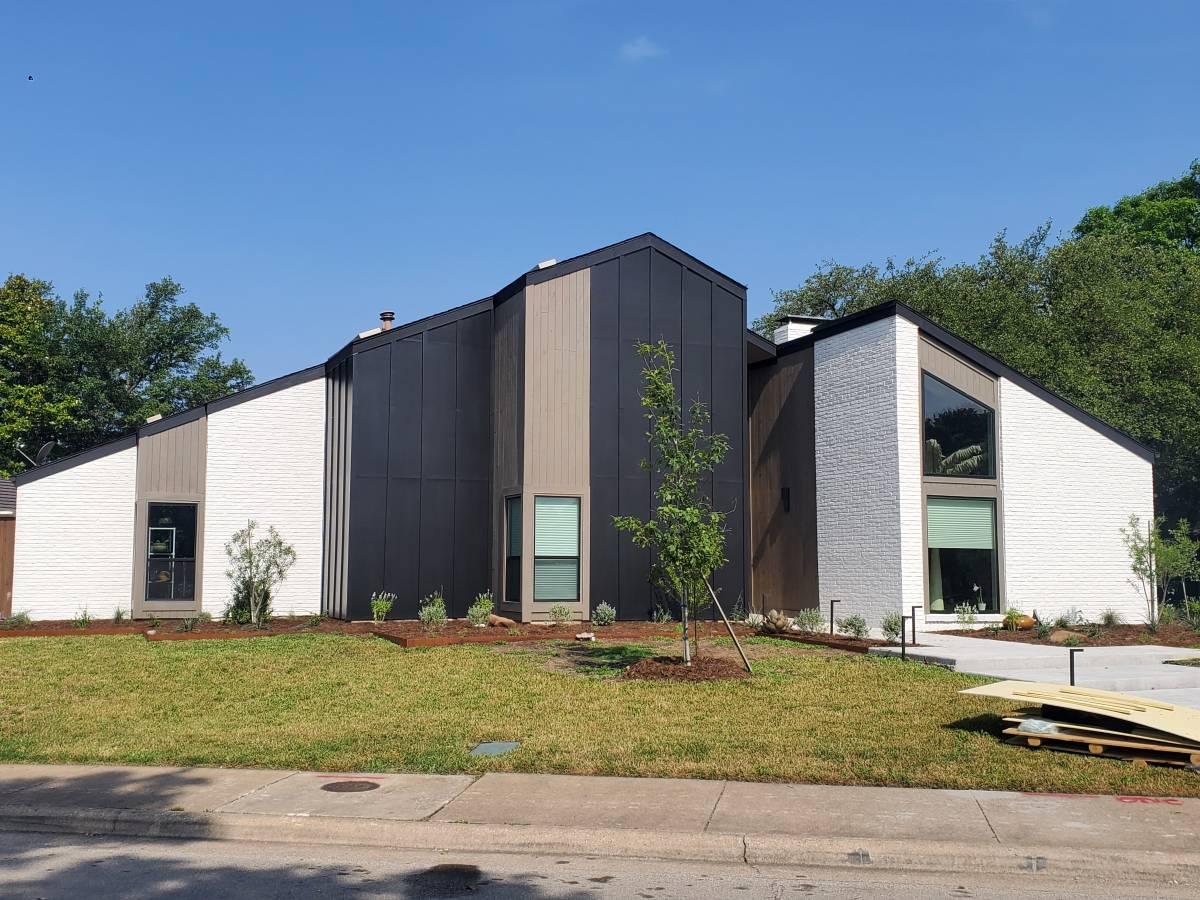Construction crew performing drywall and painting work